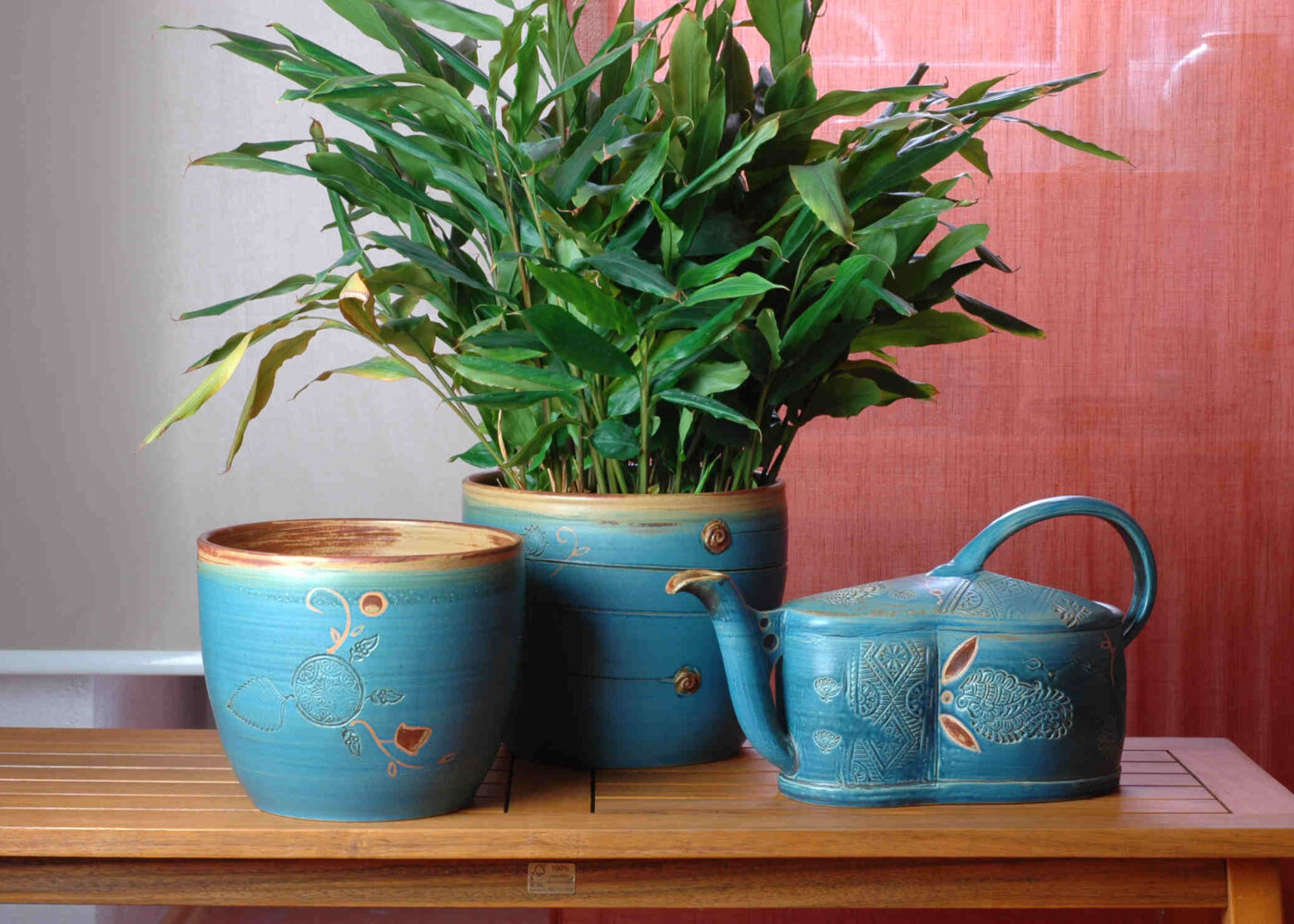 Große blaue Übertöpfe und eine Blumengießkanne